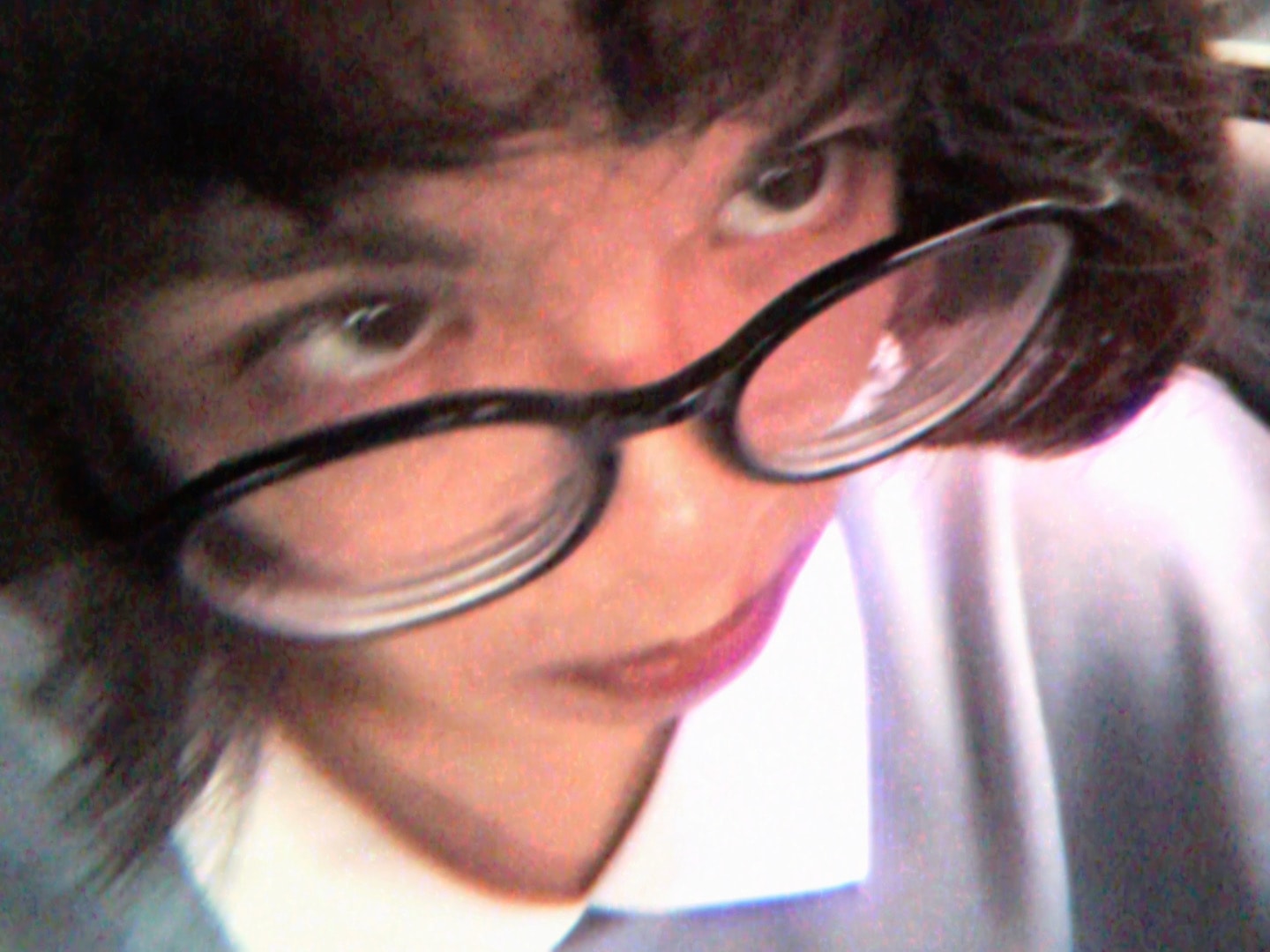ryana may que smiling with glasses tilted across her face